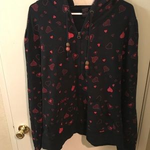 Black zip up hoodie with red hearts